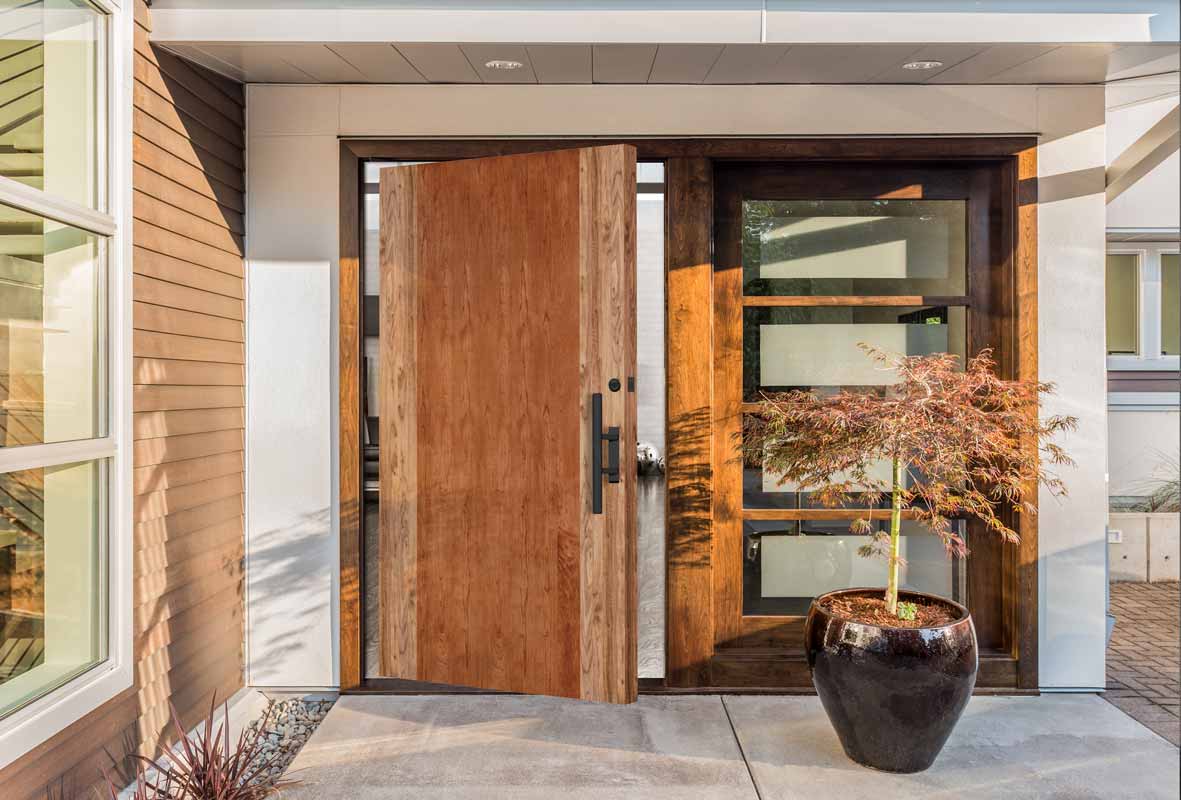 Oversized wood front door at entrance of home  
