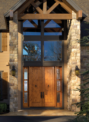 Entryway with custom knotty alder front doors